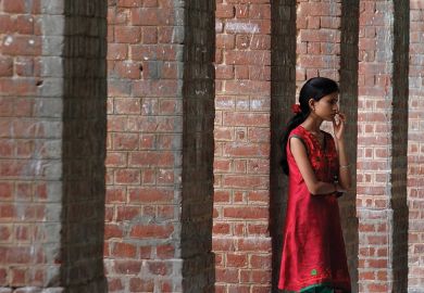 Student waiting in corridor, University of Delhi