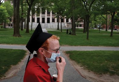 Student wearing a mask on Harvard Law School campus Student wearing a mask on Harvard Law School campus
