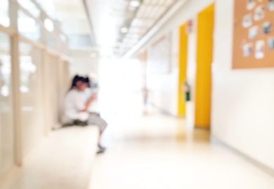 student sitting alone on walkway