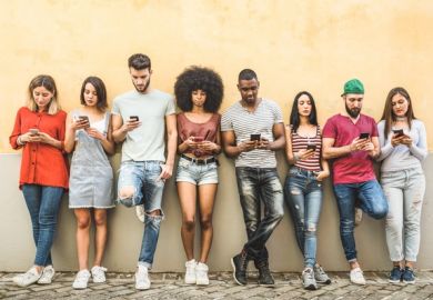 A group of students using mobile phones, symbolising student technology councils 