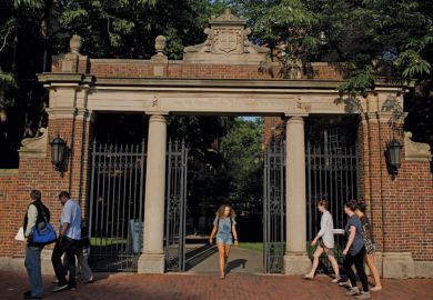 Students at Harvard University campus gate, Cambridge, Massachusetts, 2015