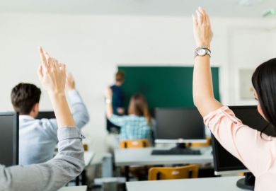Students raising hands during lesson Students raising hands during lesson