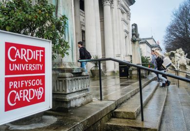 Students walking into Cardiff University campus building Students walking into Cardiff University campus building