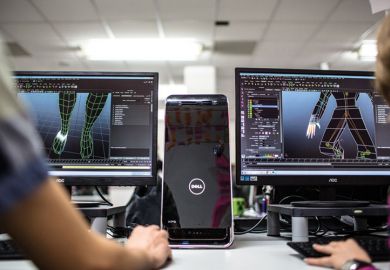 Students working with Dell desktop computers