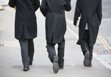 Suited Etonian men walking on street, Eton College, England