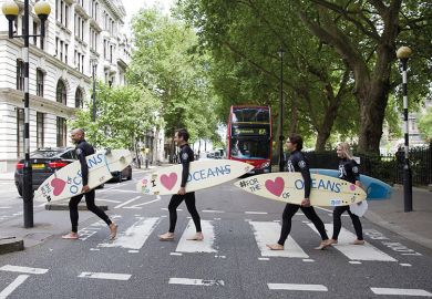 Surfers cross the road