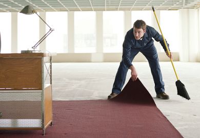 Someone sweeping something under the carpet