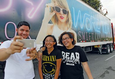 Taylor Swift fans in front of one of the many semi-trucks in Houston to illustrate For Taylor Swift, lecturers find a place in this world