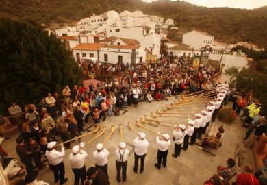 Swiss alphorn players perform in a village in Gran Canary