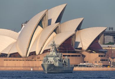 Sydney, Australia - October 5, 2013 HMAS Parramatta (FFH 154) Anzac-class frigate of the Royal Australian Navy in Sydney Harbor with the Sydney Opera House in the background.