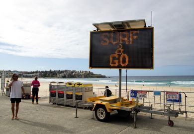 Sydney, NSW, Australia, April 28, 2020. Sign indicating that the beach is open again for surfing but not lingering