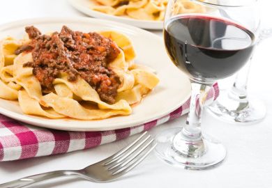 Tagliatelle with bolognese sauce and glass of red wine