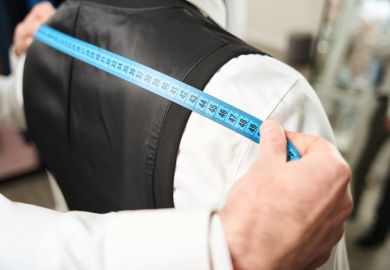 A tailor measuring someone for a suit, illustrating tailored employability training