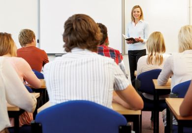 Teacher speaking at front of classroom