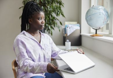 Teenage Girl Closing Lid Of Laptop