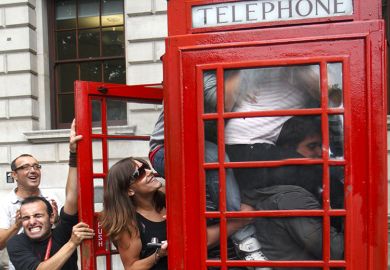 People squeezing in to a telephone box, illustrating class size increases. People squeezing in to a telephone box, illustrating class size increases.