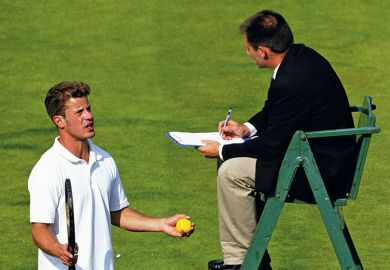 tennis player talks to umpire