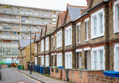 Terraced houses next to a deck-access council tower illustrating op-ed calling for recognition of rights for working-class students, staff and academics