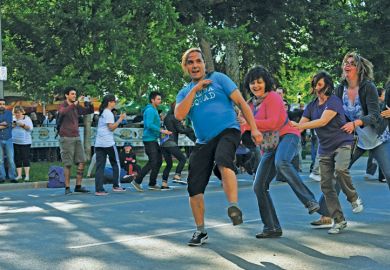 Members of the public perform the Conga dance