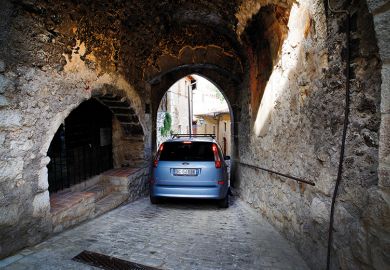 Car squeezing through a narrow arch
