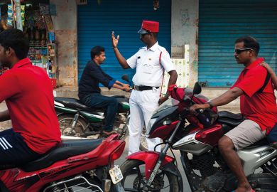 Policeman directing traffic on a street at Puducherry, India Policeman directing traffic on a street at Puducherry, India