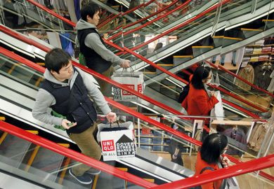 Shoppers on escalator in Tokyo Shoppers on escalator in Tokyo