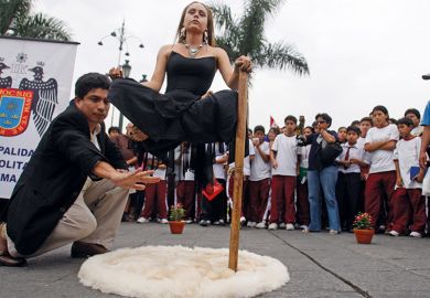 Illusionist appearing to levitate