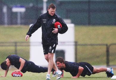 Rugby players doing press-ups