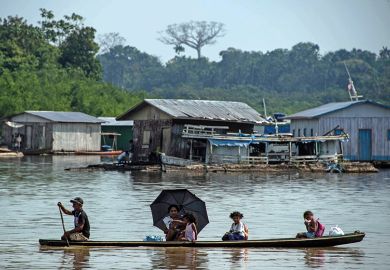 A fisherman takes his family on a canoe along the Jurua river