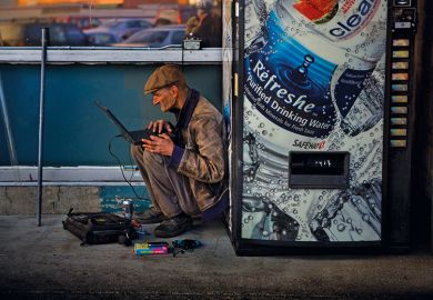 Man using computer next to vending machine