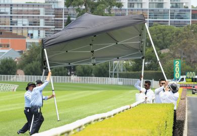 People stop a gazebo from blowing away