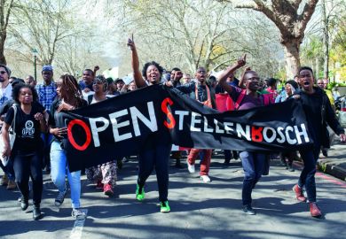 A group of students shout slogans and hold banners at Stellenbosch University in Cape Town, South Africa