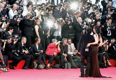 Paparazzi taking photos of stars on red carpet