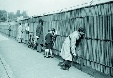 People looking through a fence