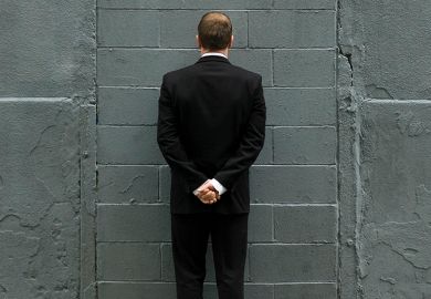Man in front of brick wall