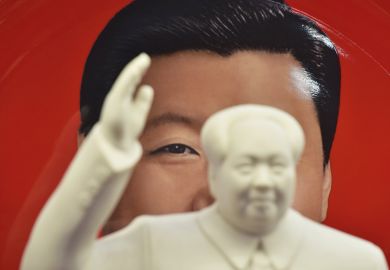 A decorative plate featuring an image of Chinese President Xi Jinping behind a statue of late communist leader Mao Zedong in a shop