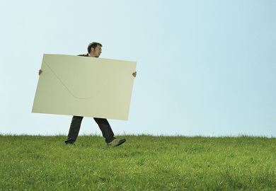 Man carrying giant envelope