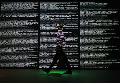 man walking past screen of code at Big Bang Data exhibition