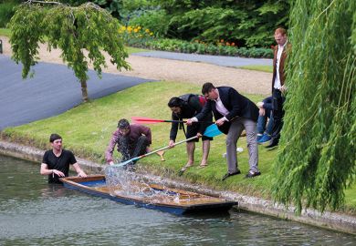 Cambridge University students on the River Cam. Punt is sinking