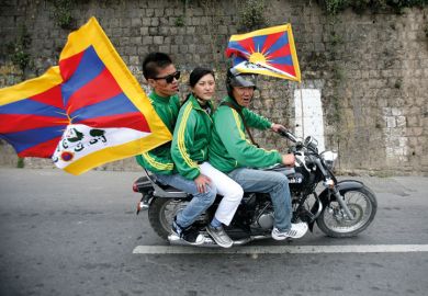 Exiled Tibetan protesters riding on motorbike