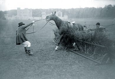 Man trying to make a horse get over a jump