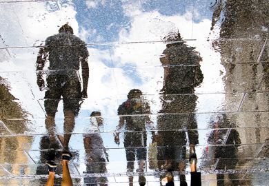 Reflection of human figures on a pavement