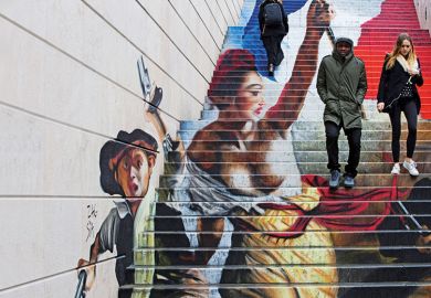 A couple walking down steps with graffiti in the background A couple walking down steps with graffiti in the background