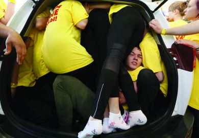 Group of students squeeze into a car