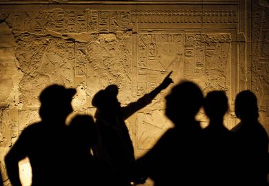 Egyptian Hieroglyphs with Tourist Archeologist Silhouettes