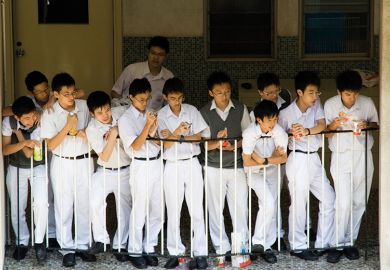 School boys watch a basketball game