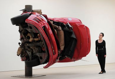 Woman standing next to art installation