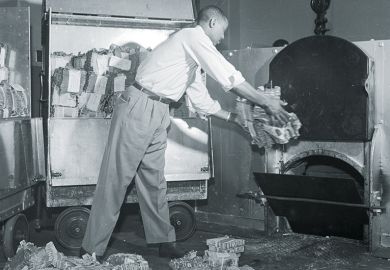 Old and tattered money being tossed into a furnace