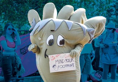 Climate protester dressed as a giant carbon footprint