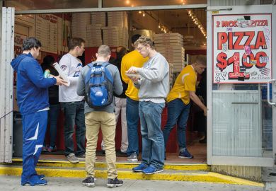 Group eating outside store selling pizza for one dollar